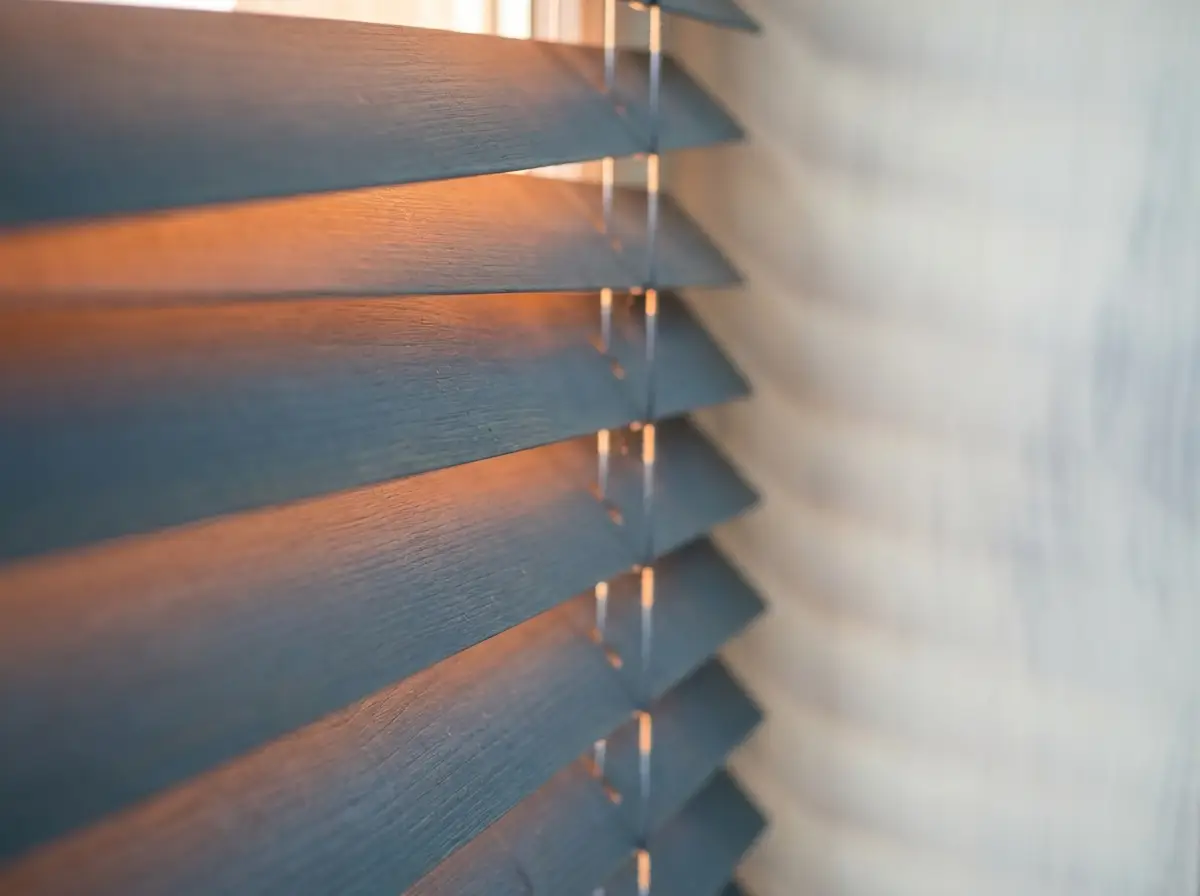 Close-up detail of blind fabric and hardware, textured neutral background
